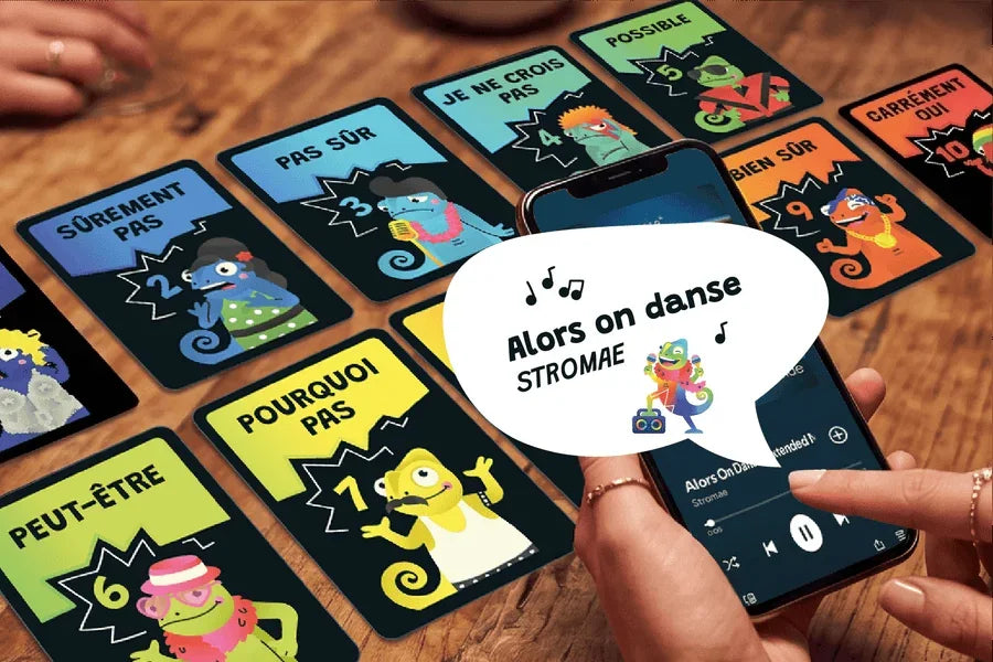 Le DJ lance « Alors on danse » sur son téléphone, les cartes Humeur sur la table